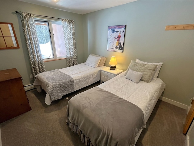 carpeted bedroom with baseboard heating and baseboards