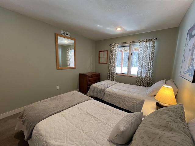 carpeted bedroom with baseboards