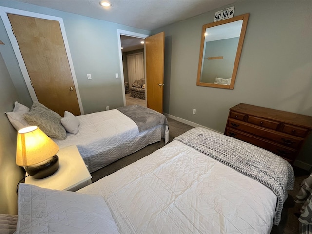 carpeted bedroom featuring baseboards