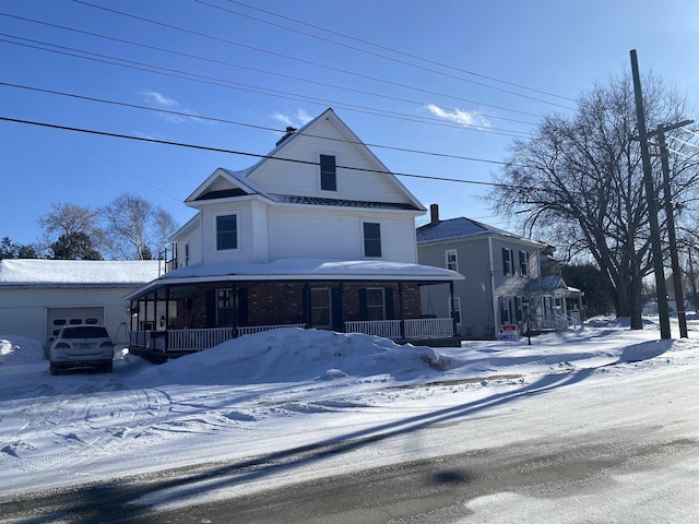 view of front of property with an attached garage and a porch