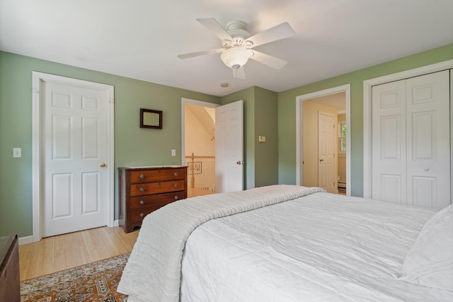 bedroom with a closet, ceiling fan, baseboards, and wood finished floors