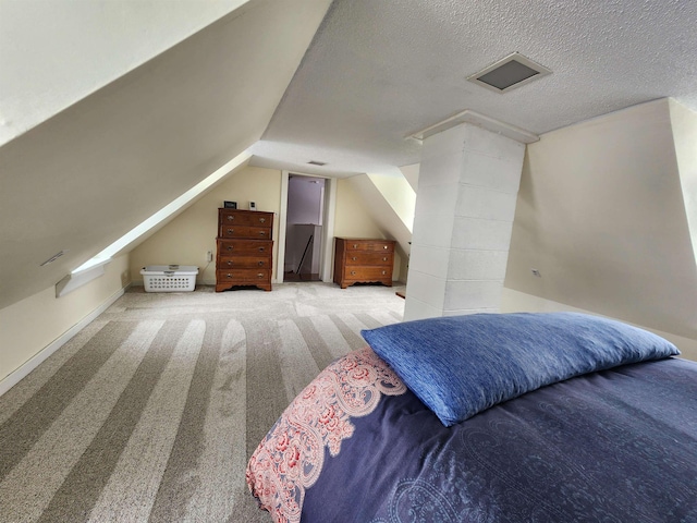 carpeted bedroom featuring lofted ceiling and a textured ceiling