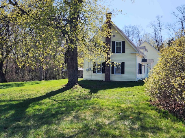 40 Ellis Ln, Claremont, NH 03743 - view of side of home with a yard and a chimney