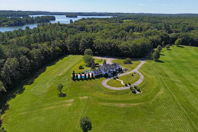 aerial view featuring a forest view and a water view