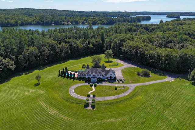 birds eye view of property featuring a water view and a wooded view