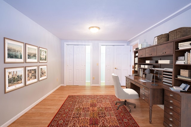 office area with wood finished floors and baseboards