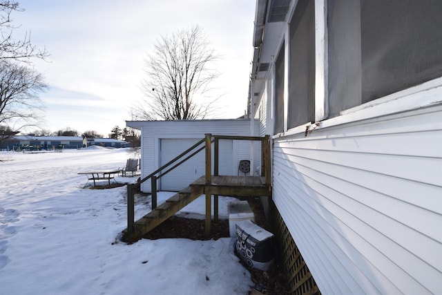 view of snowy exterior with a garage