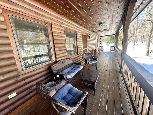 wooden terrace with a porch and outdoor lounge area