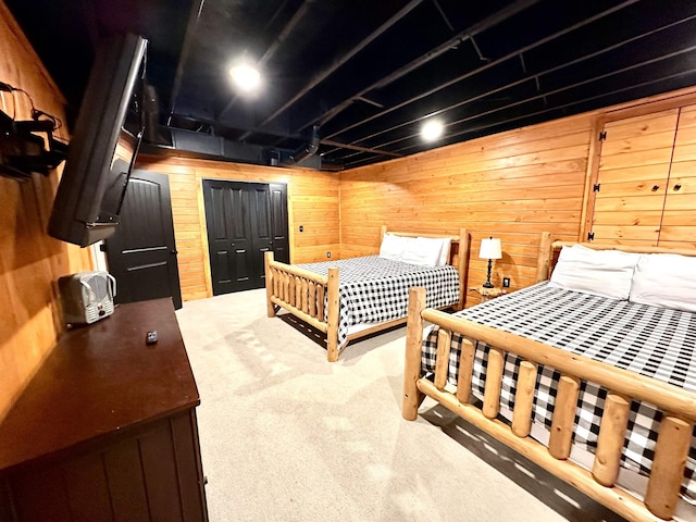 bedroom with carpet floors and wooden walls