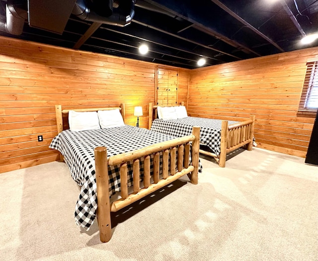 bedroom with carpet flooring and wooden walls