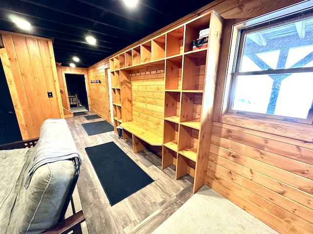 mudroom featuring wood walls and wood finished floors