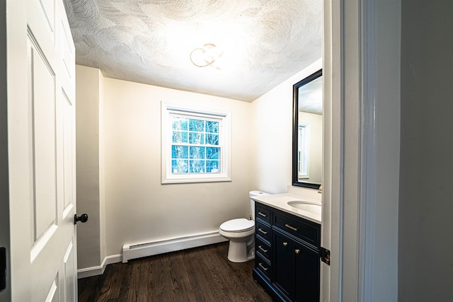 bathroom with toilet, a baseboard radiator, a textured ceiling, and wood finished floors