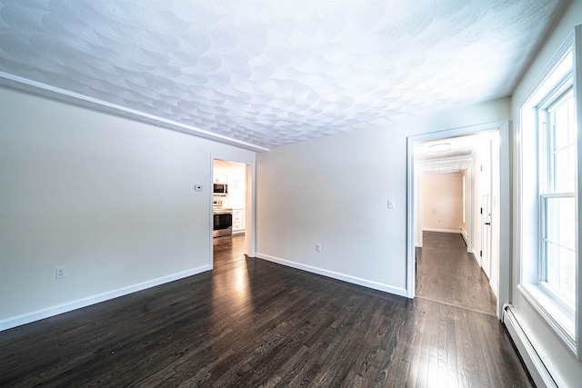 spare room with a textured ceiling, baseboards, baseboard heating, and dark wood-style flooring