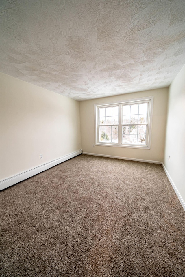 empty room with a baseboard radiator, carpet, baseboards, and a textured ceiling