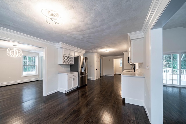 kitchen with dark wood finished floors, light countertops, a sink, and stainless steel fridge with ice dispenser