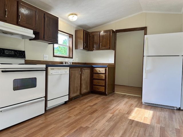 kitchen featuring crown molding, lofted ceiling, dark countertops, white appliances, and under cabinet range hood