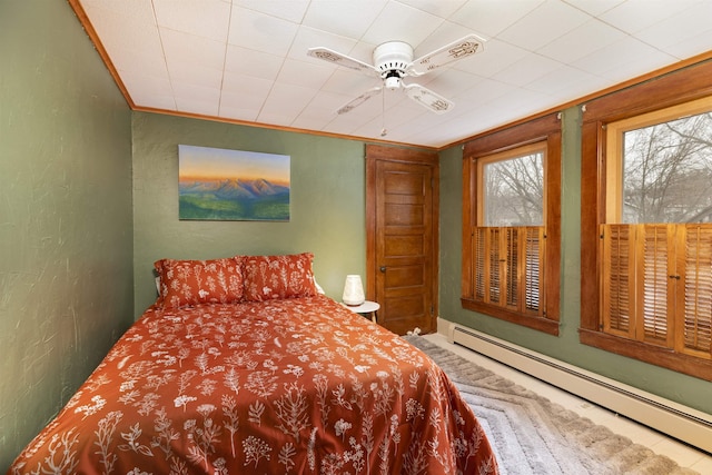 bedroom featuring a baseboard radiator, a ceiling fan, crown molding, and a textured wall