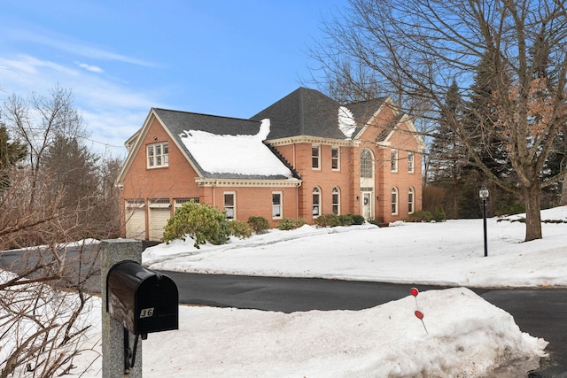 view of front of home featuring brick siding and an attached garage