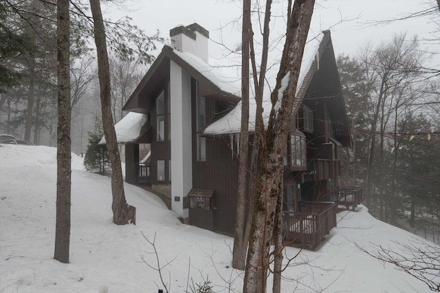 exterior space with a chimney and cooling unit