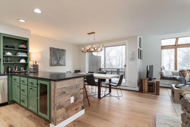 kitchen with green cabinets, a wealth of natural light, dark countertops, and light wood-style flooring