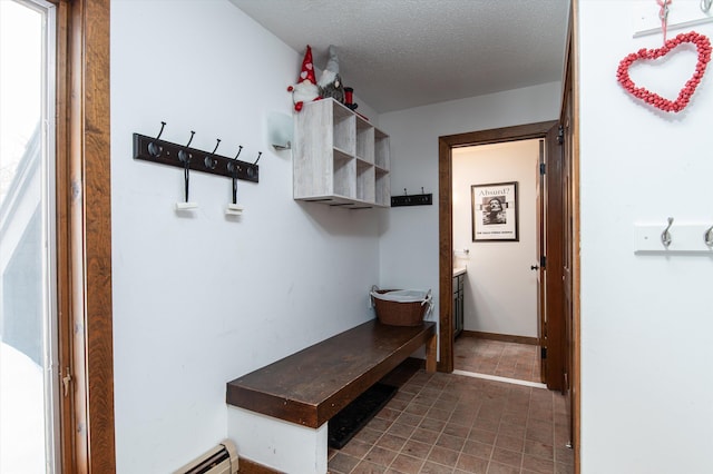 mudroom with a baseboard radiator and a textured ceiling