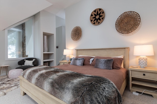 bedroom with vaulted ceiling and carpet flooring