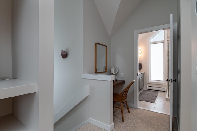 bathroom featuring a baseboard radiator, baseboards, and vaulted ceiling