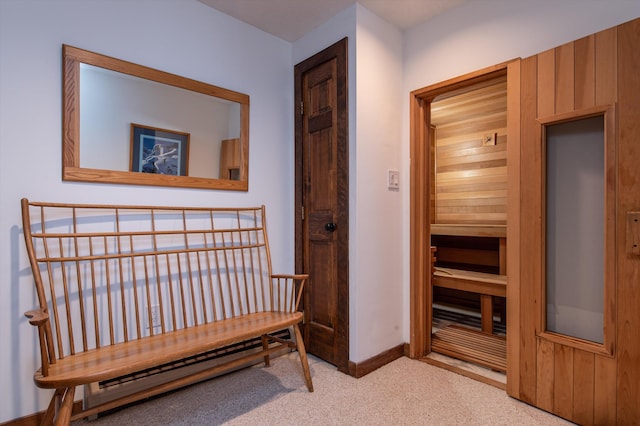 hallway featuring carpet flooring and baseboards