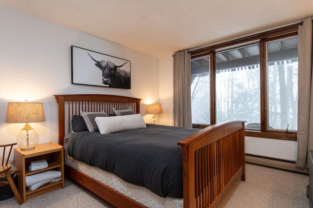 carpeted bedroom with a baseboard radiator