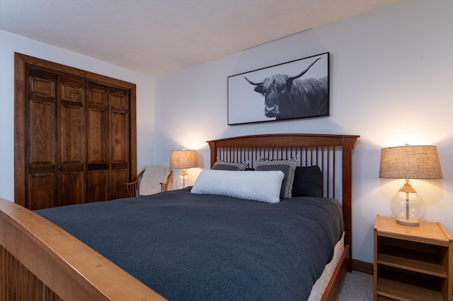 bedroom with baseboards and a closet