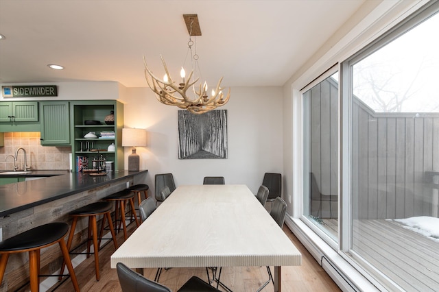 dining space featuring a chandelier, recessed lighting, and light wood-style floors