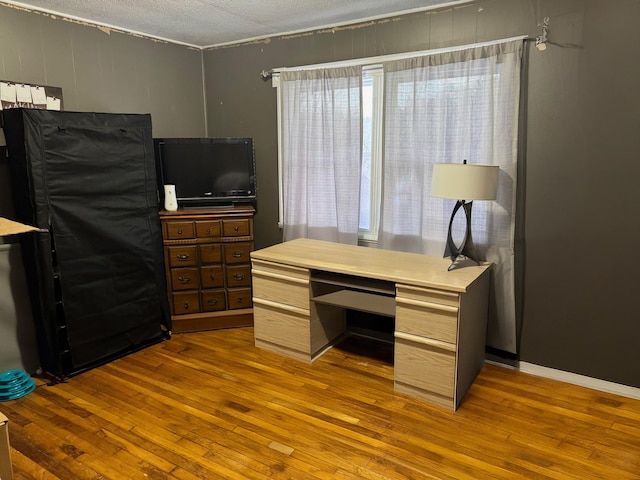 home office featuring a textured ceiling, hardwood / wood-style floors, and plenty of natural light