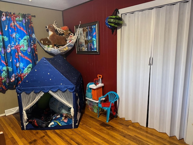 bedroom featuring hardwood / wood-style floors and visible vents