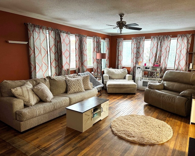 living area featuring dark wood-type flooring, crown molding, a textured ceiling, and a ceiling fan