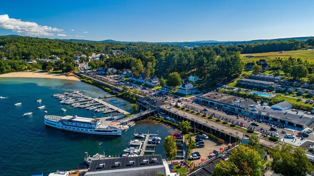 birds eye view of property with a water view and a wooded view