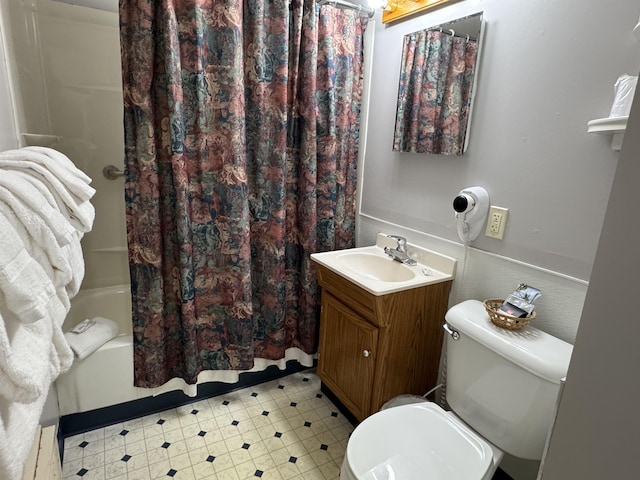 bathroom featuring vanity, tile patterned floors, toilet, and shower / tub combo with curtain