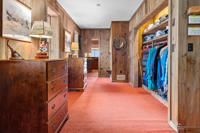 interior space featuring wooden walls and carpet flooring