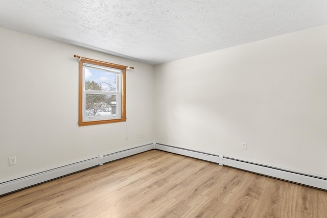 unfurnished room with a textured ceiling, a baseboard heating unit, and light wood-type flooring