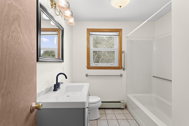 bathroom with baseboard heating, tile patterned floors, vanity, and a healthy amount of sunlight