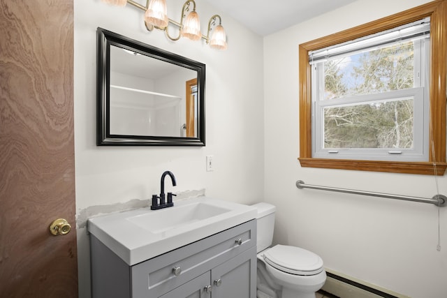 bathroom with toilet, a baseboard heating unit, and vanity