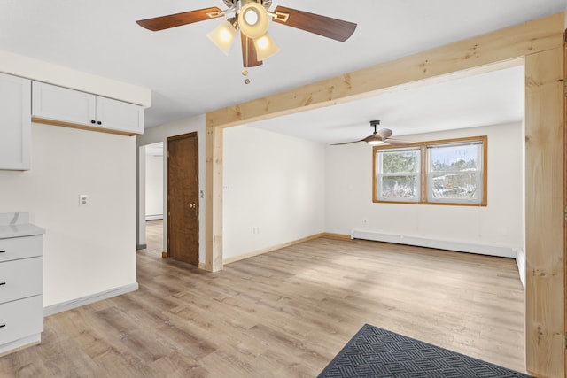 unfurnished living room with light wood finished floors, baseboards, a baseboard heating unit, and a ceiling fan