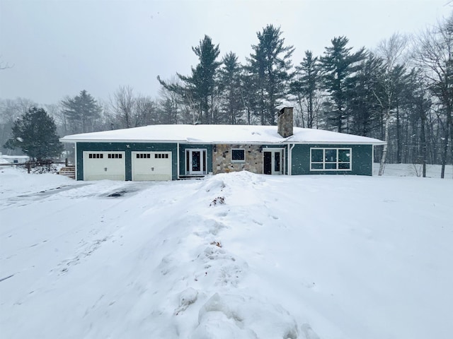 view of front facade with a chimney and an attached garage