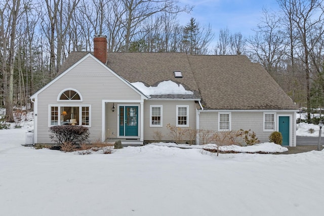 view of front of property featuring roof with shingles and a chimney