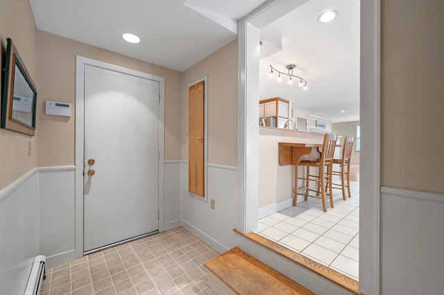 entrance foyer featuring recessed lighting, wainscoting, and baseboard heating