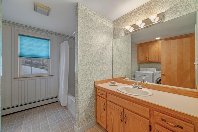 bathroom with a baseboard radiator, wallpapered walls, vanity, independent washer and dryer, and tile patterned floors