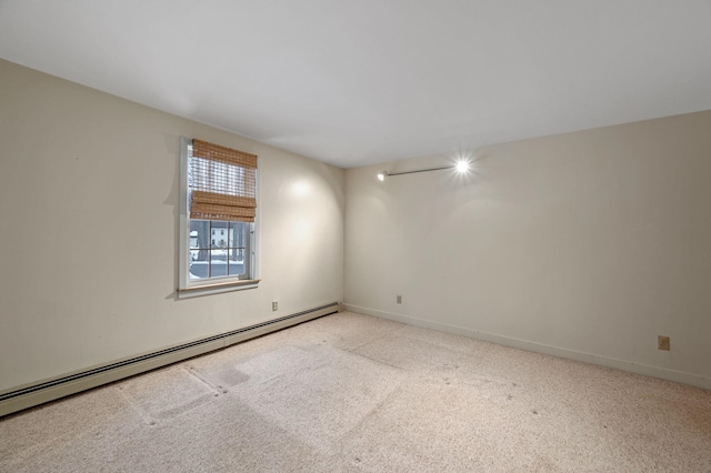 empty room with carpet, baseboards, and baseboard heating