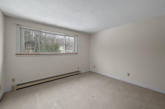 carpeted spare room featuring a baseboard radiator and baseboards