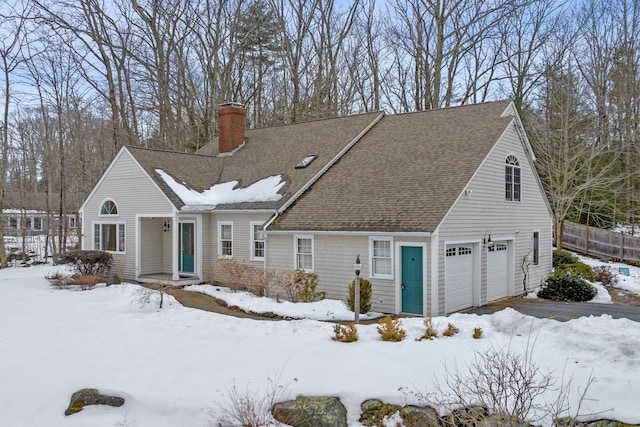 view of front facade featuring a garage, roof with shingles, fence, and a chimney