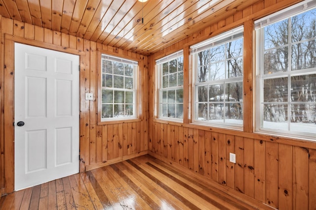 unfurnished sunroom featuring wooden ceiling and a healthy amount of sunlight