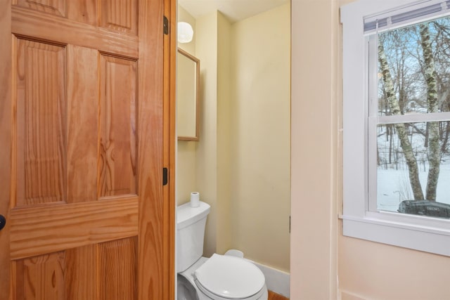 bathroom with toilet and a healthy amount of sunlight